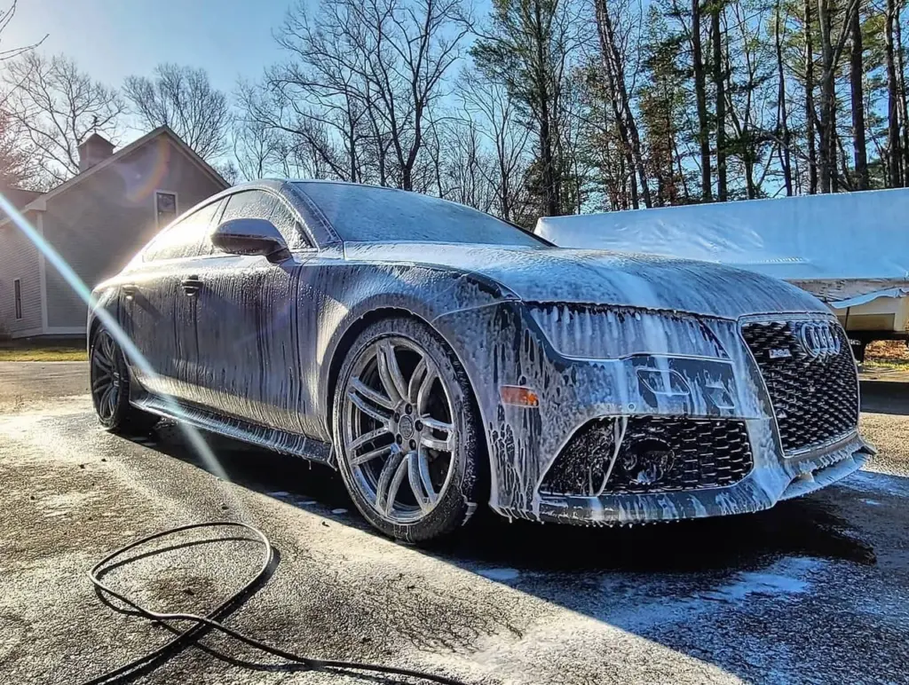 Audi RS7 luxury sedan covered in soapy water during exterior wash at driveway in Pembroke.