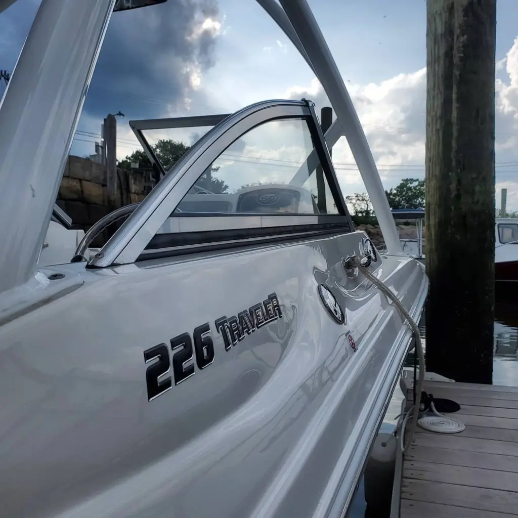 Open cabin door and window of white 226 Traveler boat moored at Pembroke marina dock.