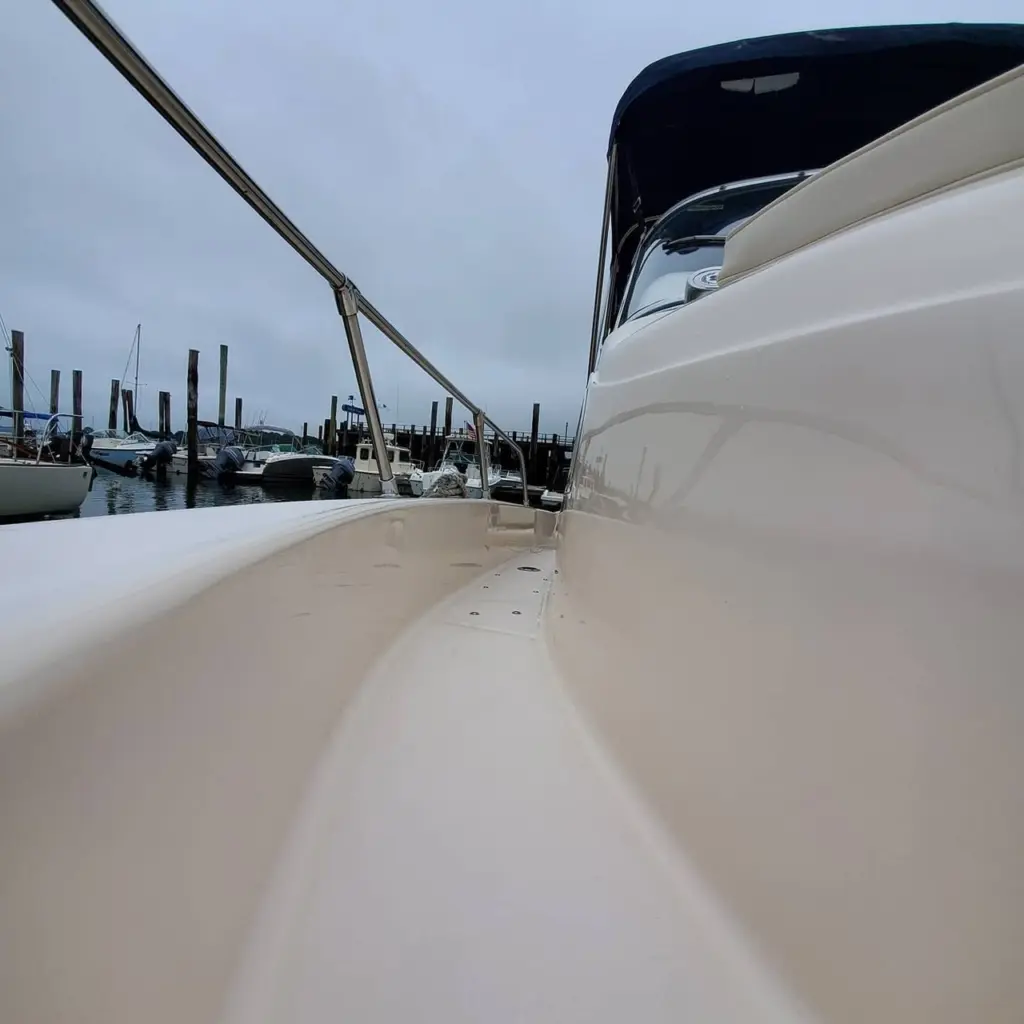 White boat deck with mooring line and marina dock pilings visible in background at Pembroke waterfront.