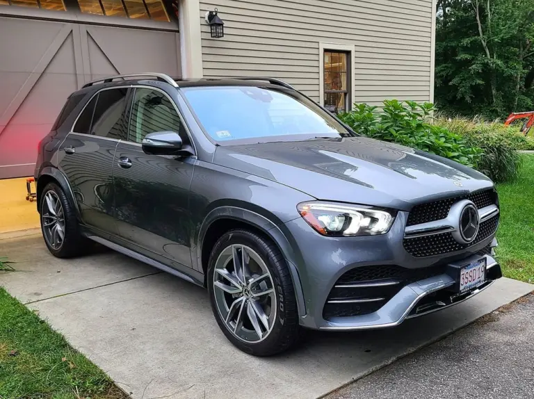 Gray Mercedes-Benz GLE SUV parked on driveway in front of residential home with garage.