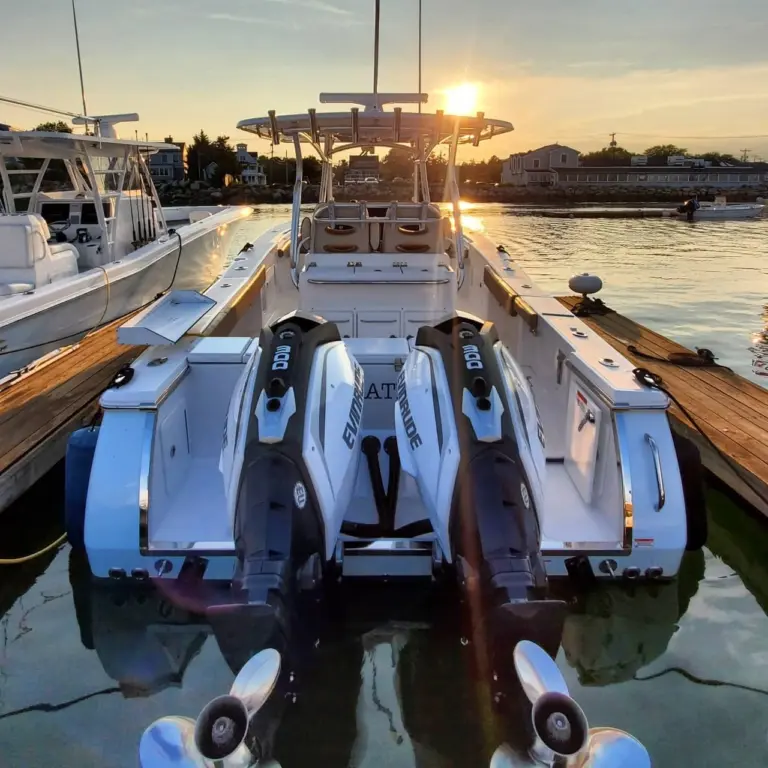 Center console boat with twin Evinrude jet skis moored at Pembroke dock at sunset.