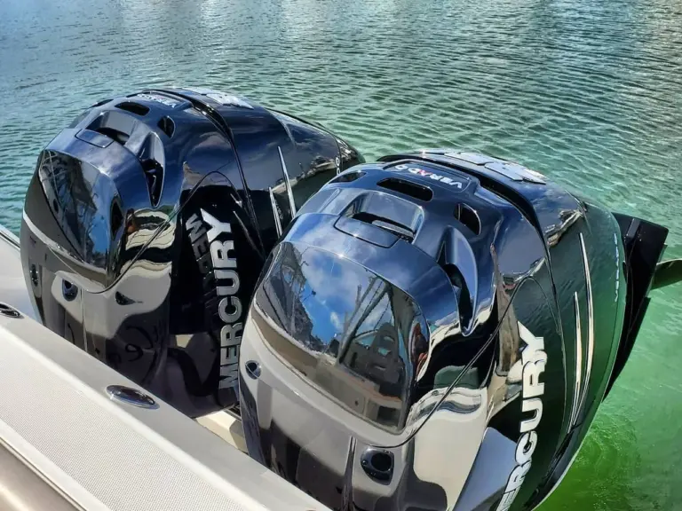 Two Mercury outboard motors mounted on the transom of a boat in Pembroke waters.